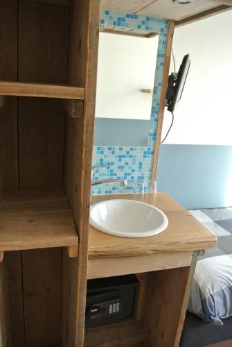a bathroom with a sink and a mirror at Bed&Breakfast aan Strand in Katwijk aan Zee