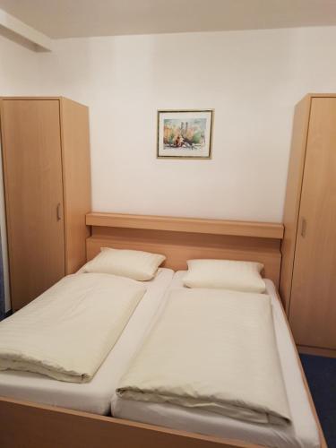 a bedroom with two beds and a picture on the wall at Hotel Giesing in Munich