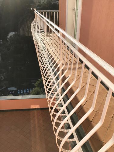 a white spiral staircase in front of a window at Il Moro Di Positano in Positano