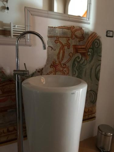 a white toilet in a bathroom with a wall at Il Moro Di Positano in Positano