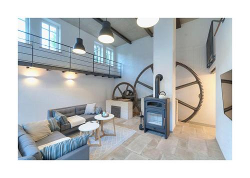 a living room with a couch and a wood stove at Pröser Mühle in Weilmünster