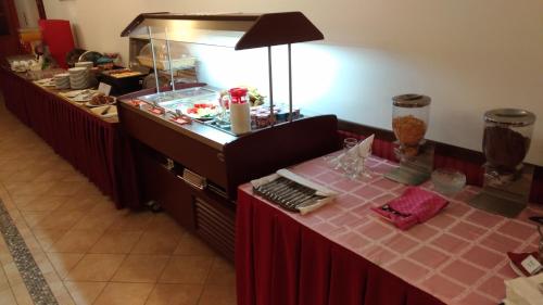 a buffet line with a table with a fish tank at Borhotel Sziluett Farkasmály in Gyöngyös