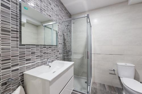 a bathroom with a sink and a toilet and a mirror at Petit Goierri in Ormáiztegui