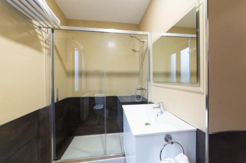 a bathroom with a glass shower and a sink at Petit Goierri in Ormáiztegui