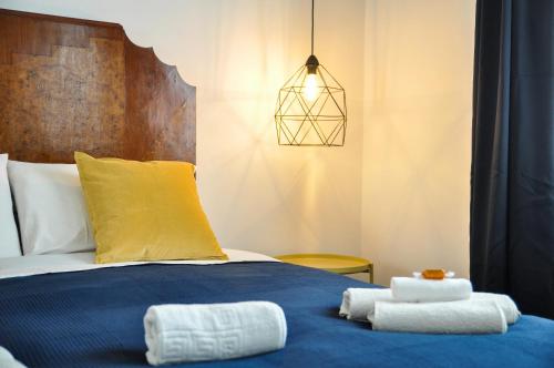 a bedroom with a bed with towels on it at Anita & Garibaldi in Marsala