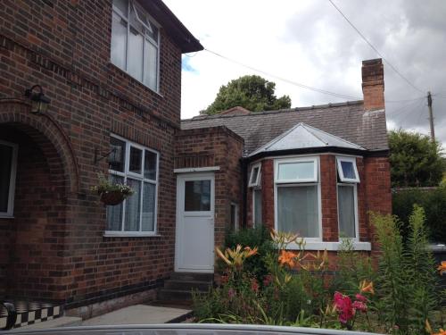 a red brick house with a white door at Bramblhen in Nottingham