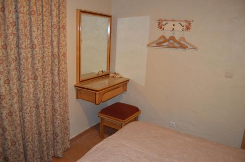a bedroom with a bed and a dresser and a mirror at Monte Chalaça - Turismo Rural in Ferreira do Alentejo