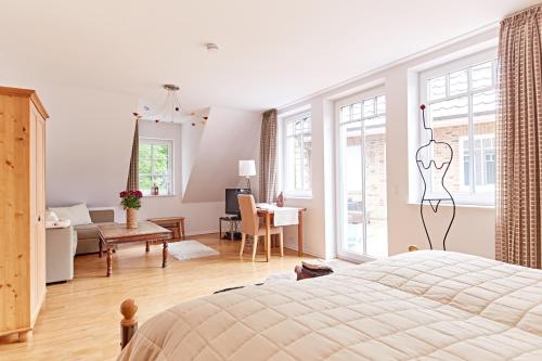 a bedroom with a bed and a living room at Eichenlodge in Apensen