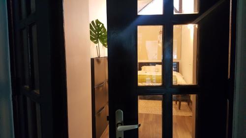 a door leading into a room with a potted plant at CozyBeach large 1BdrApt 50 steps from Atlantic Ocean private street between Ocean Park & Isla Verde 5 mins from Airport in San Juan