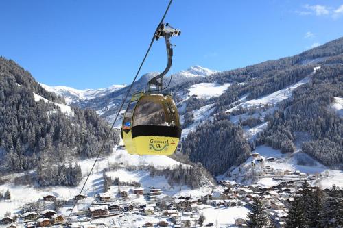 a ski lift in the middle of a snow covered mountain at Naturhaus Andrea in Grossarl