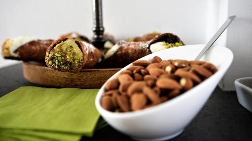 a white bowl of beans and a bowl of food at Palazzo Sisto Exclusive Rooms in Catania