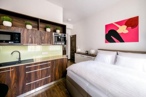 a bedroom with a bed and a sink in it at Fifty Shades of Gray studio, city center in Hradec Králové