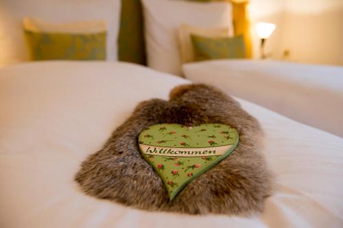 a stuffed animal with a heart on a bed at Chalet Kerber in Lech am Arlberg