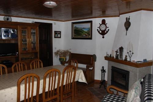 a dining room with a table and a fireplace at Sobrado Fonseca in Paredes do Rio