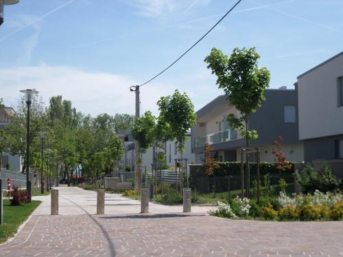 a street with houses and trees and a sidewalk at Silver DeLux Apartman in Balatonfüred
