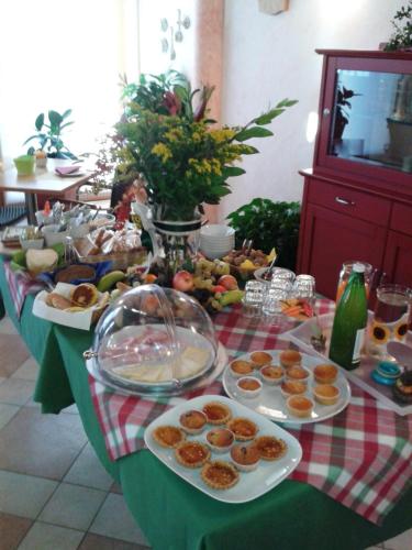 a table with plates of food on top of it at Agriturismo B&B Il Girasole in Oriago Di Mira