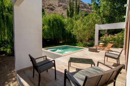 a patio with chairs and a swimming pool at Aldea del Valle - Elqui Villas, Pisco Elqui in Pisco Elqui