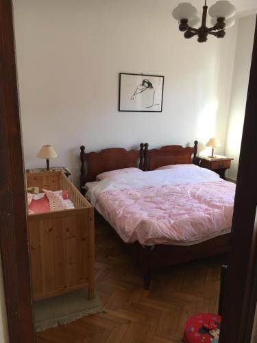 a bedroom with a bed with a pink comforter at APP Rojko in Lovrečica