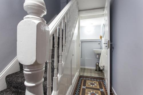 a hallway with a stairway with a white stair railing at Northwood Park View in Stoke on Trent