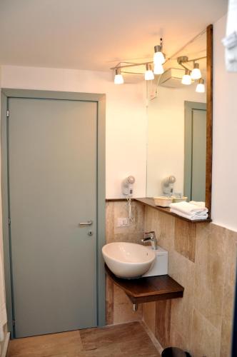 a bathroom with a sink and a mirror at Gil's Hotel in Olbia