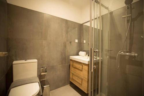 a bathroom with a shower and a toilet and a sink at Olá Lisbon - Chiado III in Lisbon
