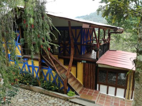 a house with a staircase in front of it at Ecorefugio Las Mirlas in Salento