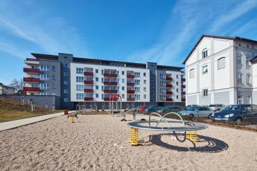 an empty playground in front of a large building at Apartmán Berenika in Vrchlabí