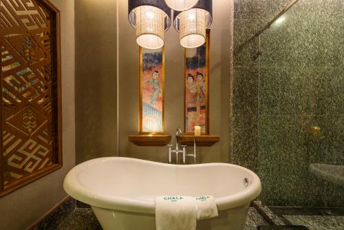 a bathroom with a bath tub and a shower at Chala Number6 in Chiang Mai