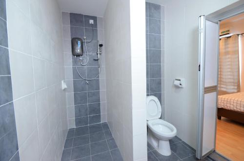 a bathroom with a toilet and a shower at Decozy Homestay (14pax++) in Ipoh
