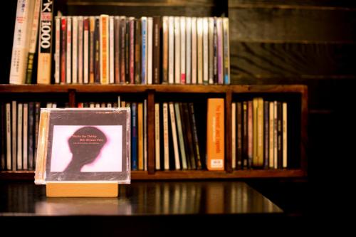 a book sitting on a book shelf with books at Hotel Miyajima Villa in Miyajima