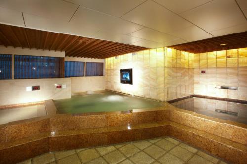 an empty swimming pool in a room with at Novotel Ambassador Seoul Gangnam in Seoul