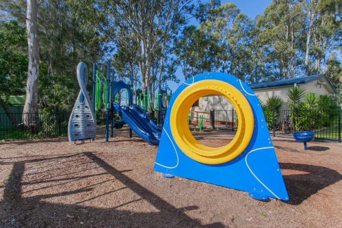 a playground with a blue and yellow slide at BIG4 Karuah Jetty Holiday Park in Karuah