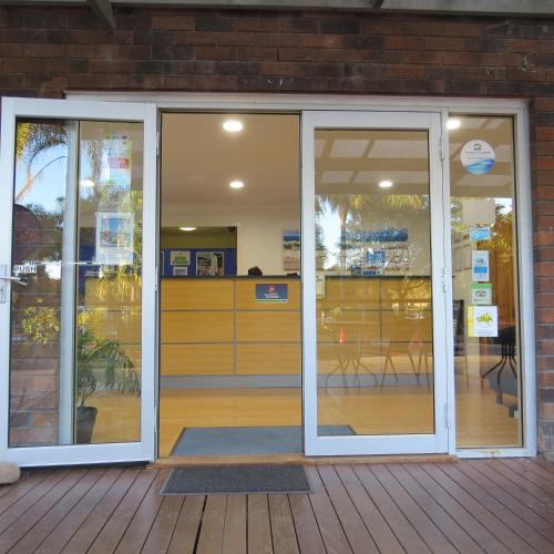 an entrance to a store with sliding glass doors at BIG4 Karuah Jetty Holiday Park in Karuah