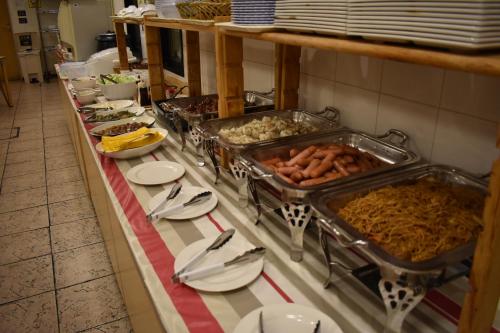a buffet of food on a table in a restaurant at Hotel Crown Hills Toyokawa in Toyokawa