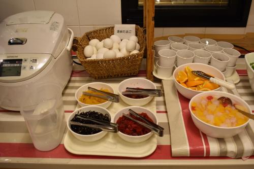 a table topped with bowls of food and a mixer at Hotel Crown Hills Toyokawa in Toyokawa