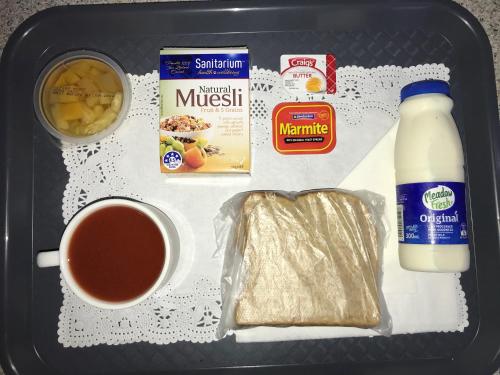 a lunch box with a cup of coffee and some food at Southern Comfort Motel in Christchurch