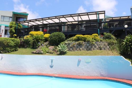 a swimming pool at a resort with a building at Breakerview in Shelly Beach
