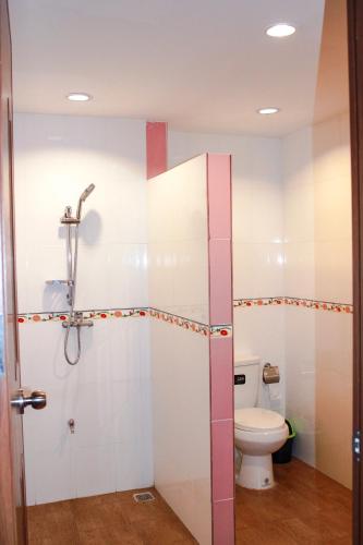 a bathroom with a shower and a toilet at Menam Resort in Nakhon Pathom