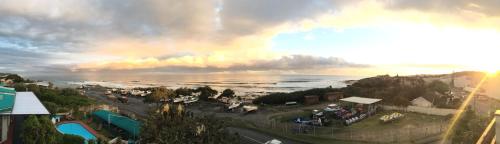 a view of the ocean with a rainbow in the sky at Breakerview in Shelly Beach