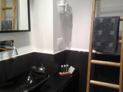 a bathroom with a sink and a mirror at Arco' B&B Trani Cattedrale in Trani