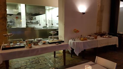 two tables in a kitchen with food on them at Château Les Merles et ses Villas in Mouleydier