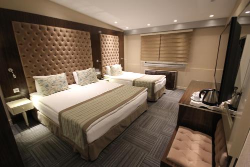 Postel nebo postele na pokoji v ubytování Ankara Gold Hotel