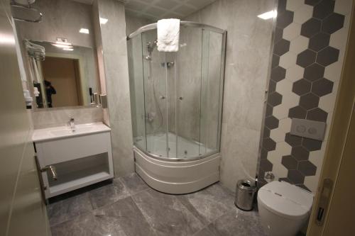 a bathroom with a shower, toilet, sink and tub at Ankara Gold Hotel in Ankara
