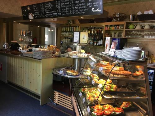 a bakery counter with a lot of food on display at Cafe-Restaurant & Hotel Saima in Savonlinna