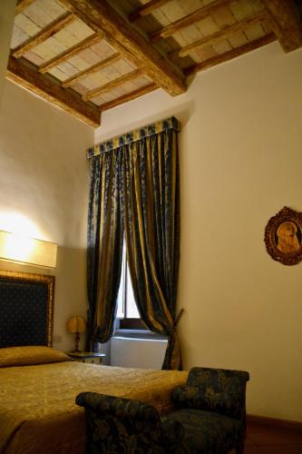 a bedroom with a bed and a window with curtains at Hotel Italia in Foligno