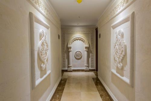 a hallway with paintings on the walls of a building at Kaya Ninova Hotel in Mardin
