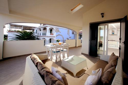 a living room with a couch and a table at Residenze Gli Ulivi in Orosei