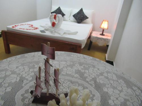 a room with a table with a bed and a tableablishthritisthritisthritisthritis at Relax Beach House in Tangalle
