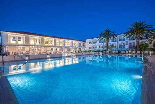 a large swimming pool in front of a building at Zante Park Resort & Spa BW Premier Collection in Laganas