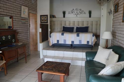 a living room with a bed and a couch at Breakerview in Shelly Beach